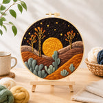 Finished sunset in the desert needle felting displayed on a wooden easel