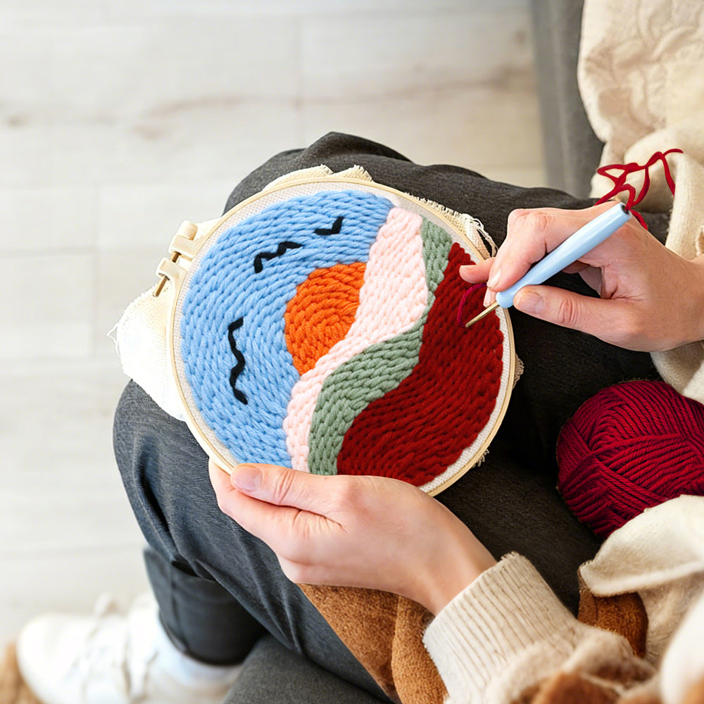 Creating handmade sunset mountains and birds punch needle artwork
