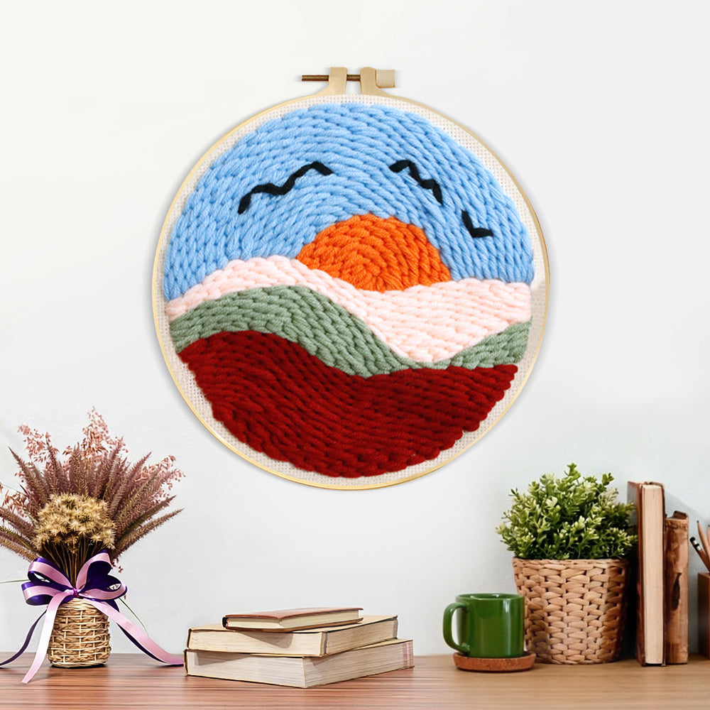 Finished sunset mountains and birds artwork displayed on a wall