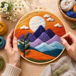 Creating the sunset purple mountains and green sprig wool painting by hand with a felting needle