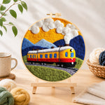 Finished sunset steam train needle felting displayed on a wooden easel