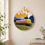Sunset steam train needle felt wall art displayed in a bright home interior