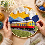 Creating the sunset steam train wool painting by hand with a felting needle