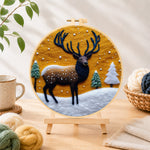Finished sunset winter stag needle felting displayed on a wooden easel