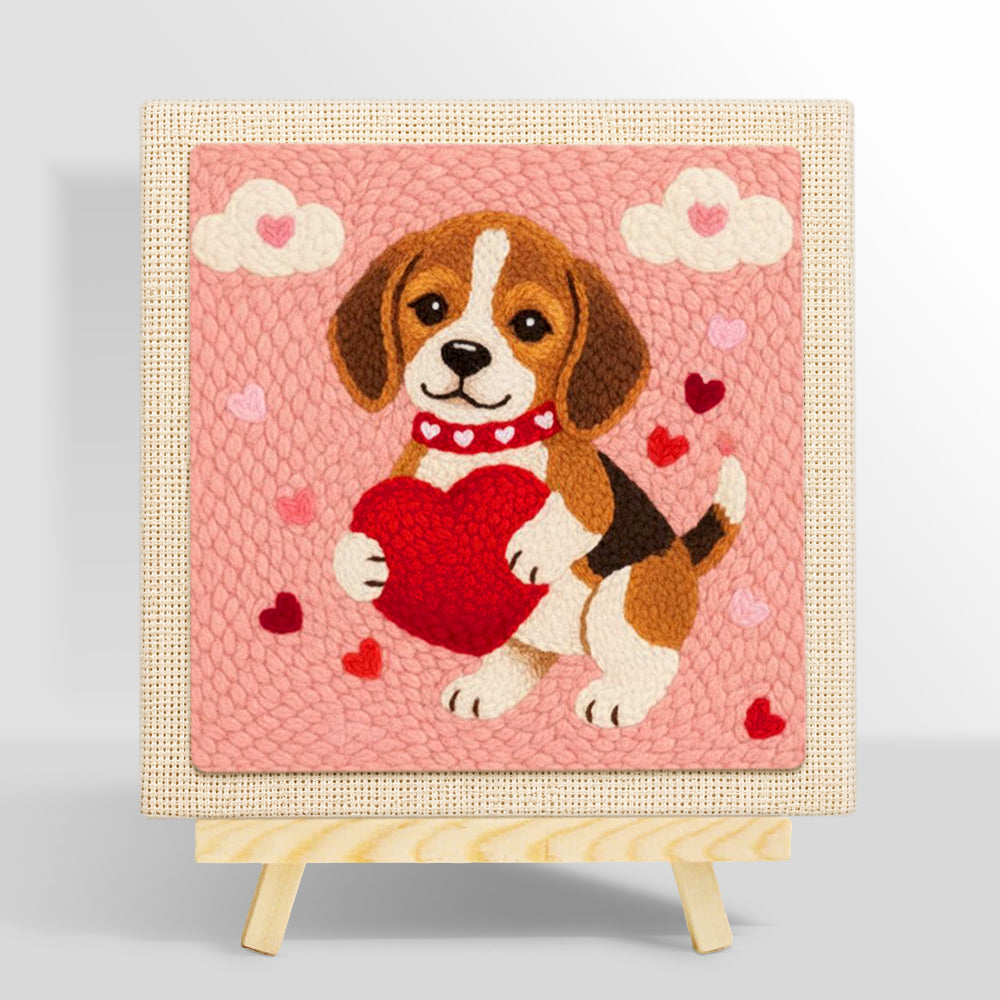 Sweet beagle puppy holding a big heart punch needle kit for beginners