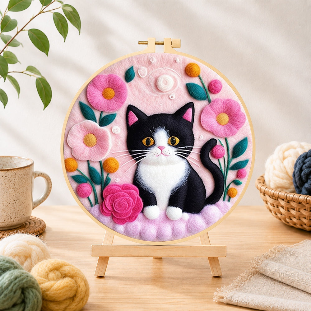 Finished sweet black and white cat with flowers needle felting displayed on a wooden easel