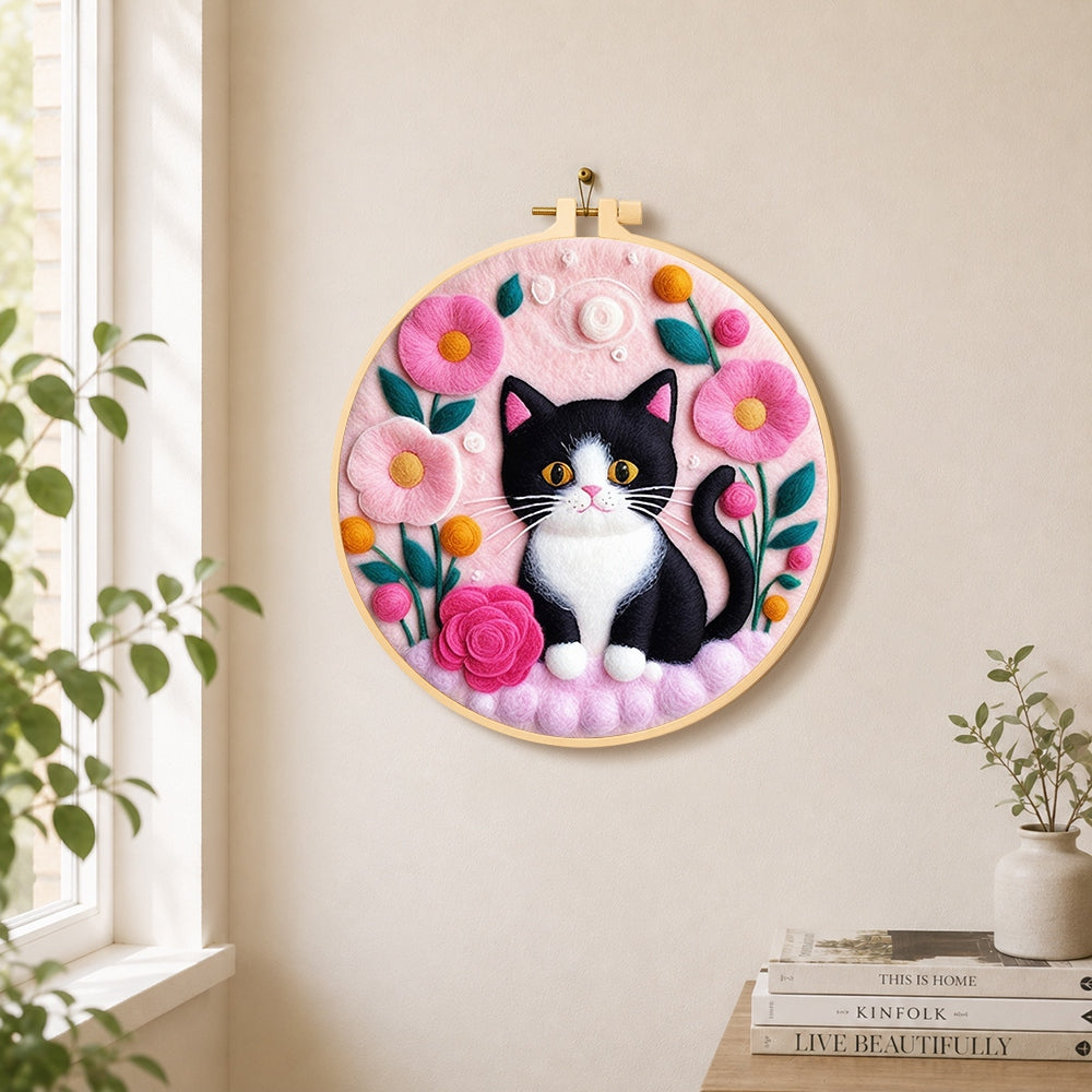 Sweet black and white cat with flowers needle felt wall art displayed in a bright home interior