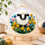 Finished sweet black-faced lamb in floral garden needle felting displayed on a wooden easel