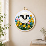 Sweet black-faced lamb in floral garden needle felt wall art displayed in a bright home interior