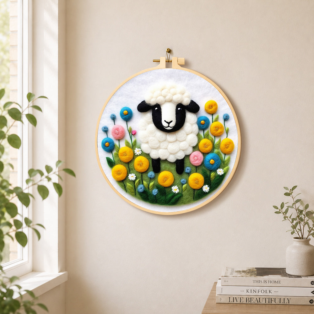 Sweet black-faced lamb in floral garden needle felt wall art displayed in a bright home interior