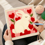 Creating handmade sweet bunny with flower hearts punch needle artwork