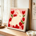 Sweet bunny with flower hearts punch needle artwork displayed on a table