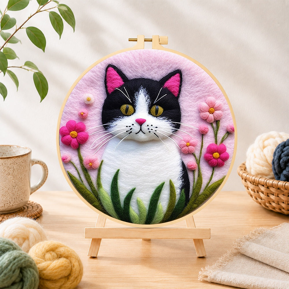 Finished sweet cat and vibrant pink flowers needle felting displayed on a wooden easel