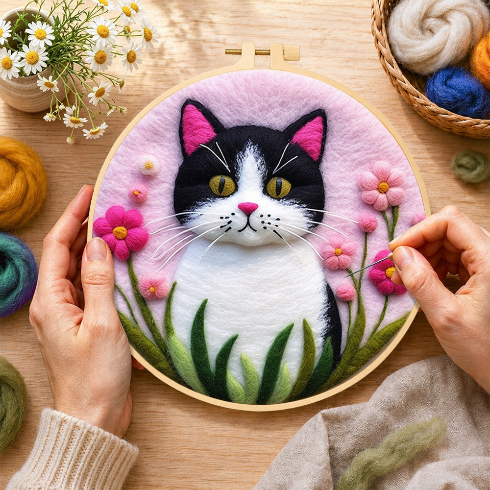 Creating the sweet cat and vibrant pink flowers wool painting by hand with a felting needle