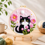 Finished sweet cat with pink flowers needle felting displayed on a wooden easel