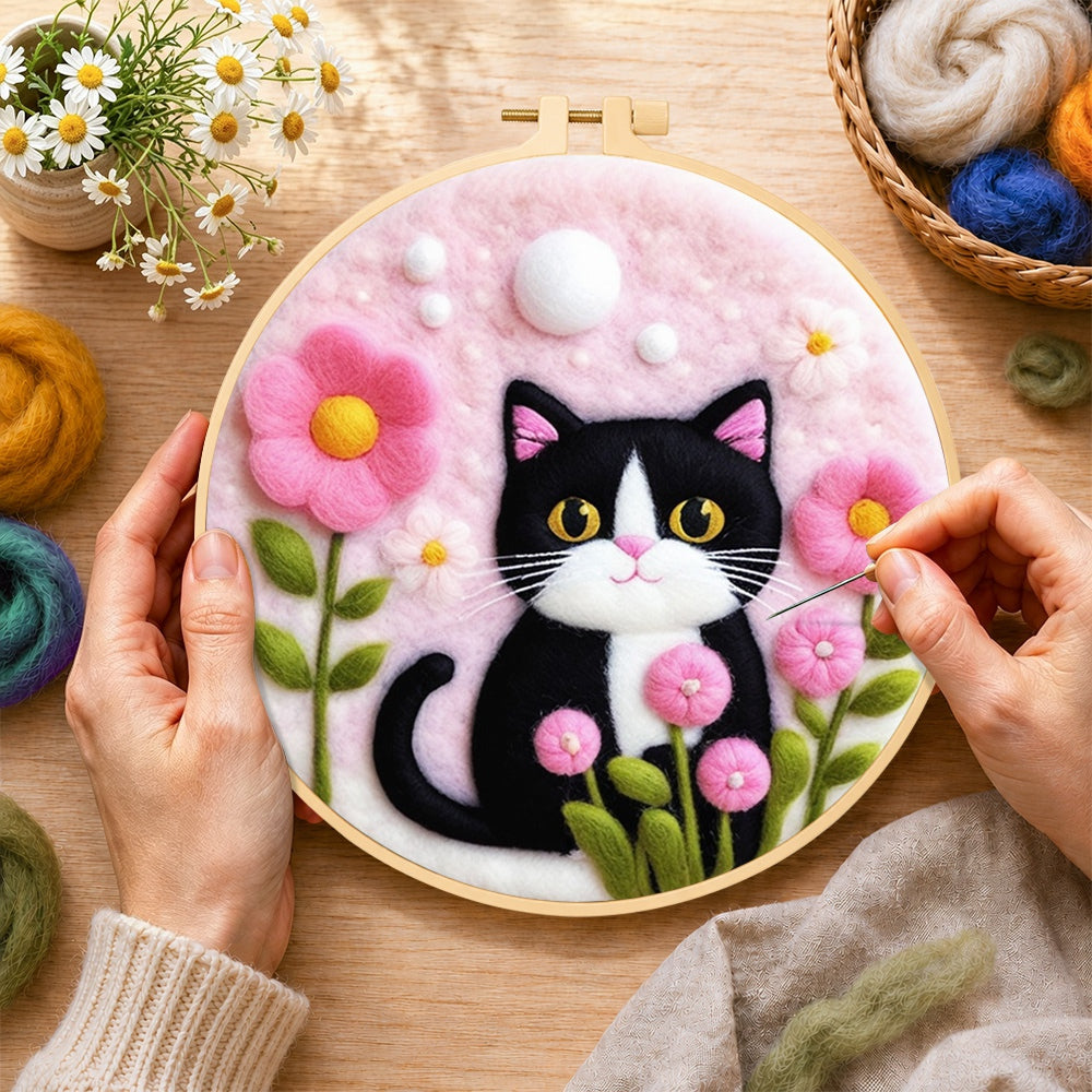 Creating the sweet cat with pink flowers wool painting by hand with a felting needle