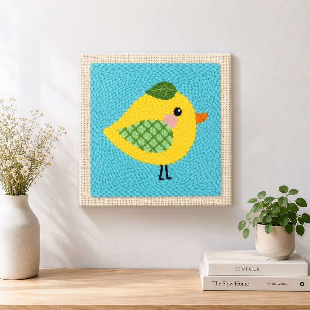 Finished sweet little yellow bird with green wing artwork displayed on a wall