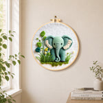 Sweet mint green elephant and plants needle felt wall art displayed in a bright home interior