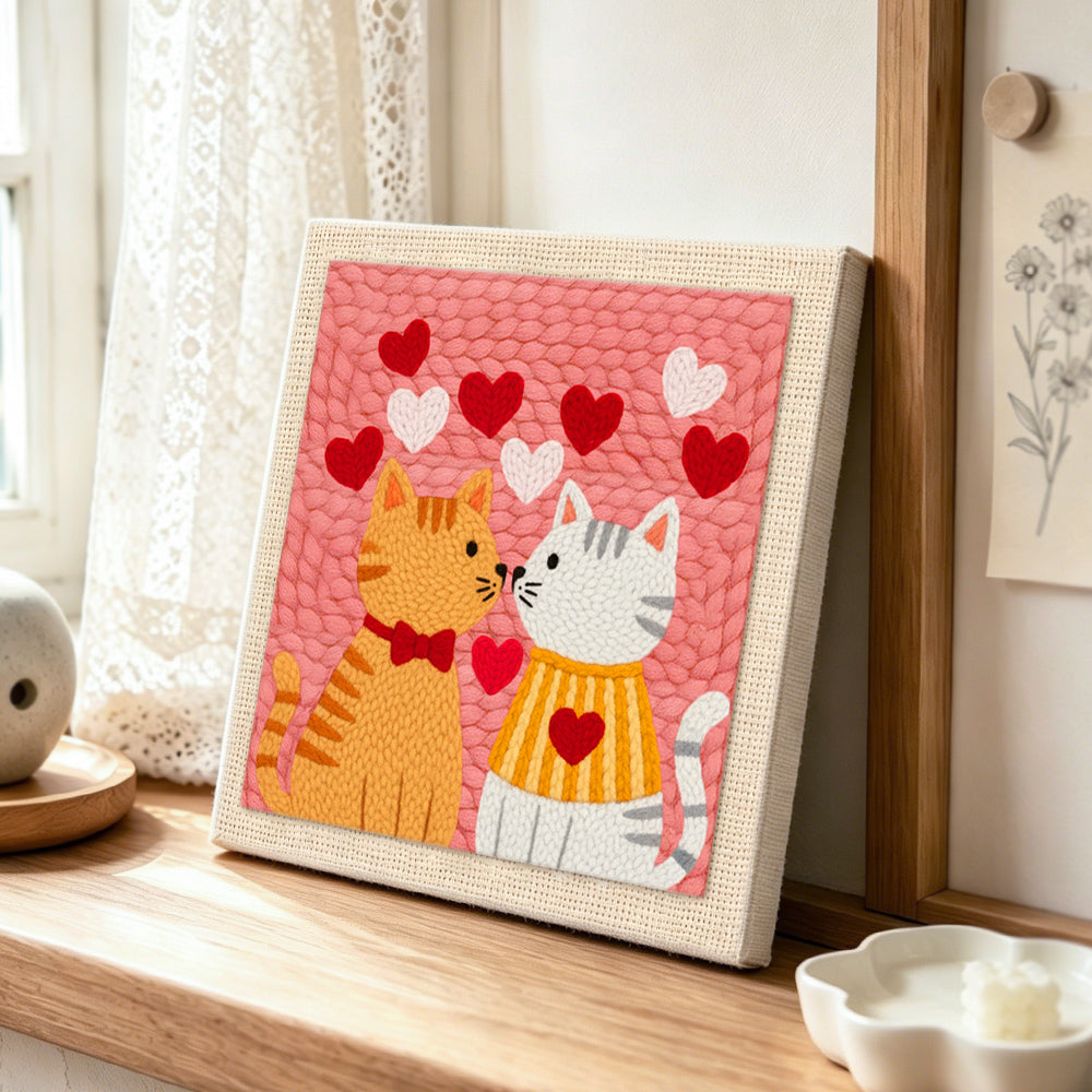 Sweet nose-to-nose cat couple punch needle artwork displayed on a table