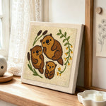 Sweet otter family punch needle artwork displayed on a table