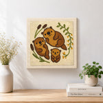 Finished sweet otter family artwork displayed on a wall