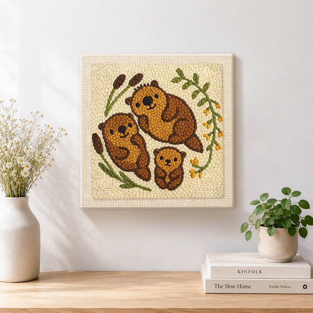 Finished sweet otter family artwork displayed on a wall