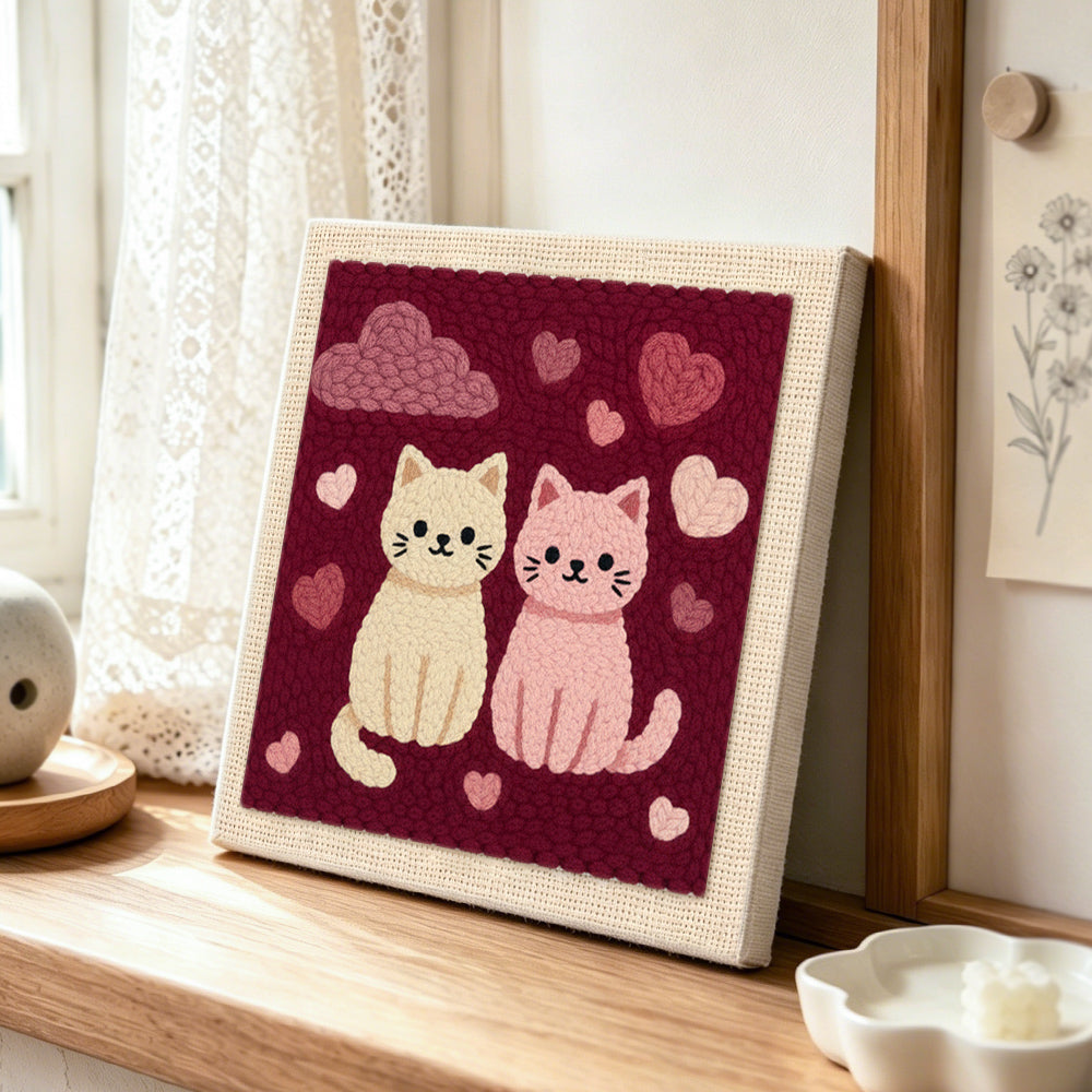 Sweet pink and cream cat couple punch needle artwork displayed on a table