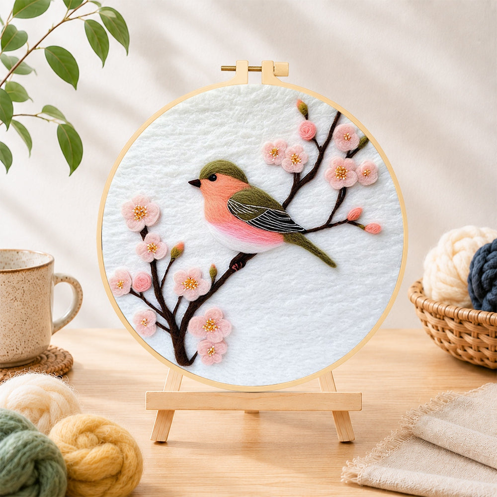 Finished sweet pink blossom bird needle felting displayed on a wooden easel
