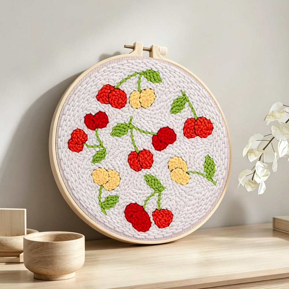 Sweet red and yellow cherries punch needle artwork displayed on a table