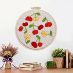 Finished sweet red and yellow cherries artwork displayed on a wall