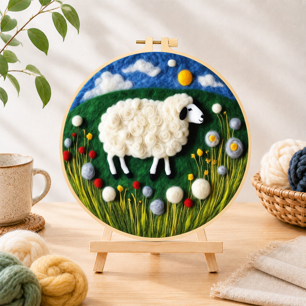 Finished sweet sheep on a green rolling hill needle felting displayed on a wooden easel