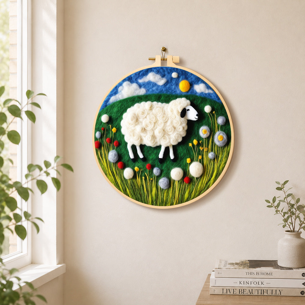 Sweet sheep on a green rolling hill needle felt wall art displayed in a bright home interior