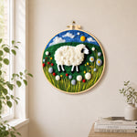 Sweet sheep on a green rolling hill needle felt wall art displayed in a bright home interior