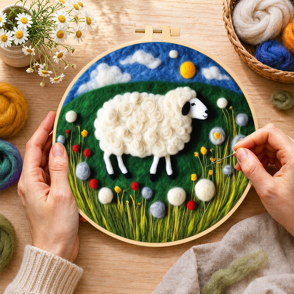 Creating the sweet sheep on a green rolling hill wool painting by hand with a felting needle