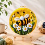 Finished sweet smiling bee with daisies needle felting displayed on a wooden easel