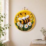 Sweet smiling bee with daisies needle felt wall art displayed in a bright home interior