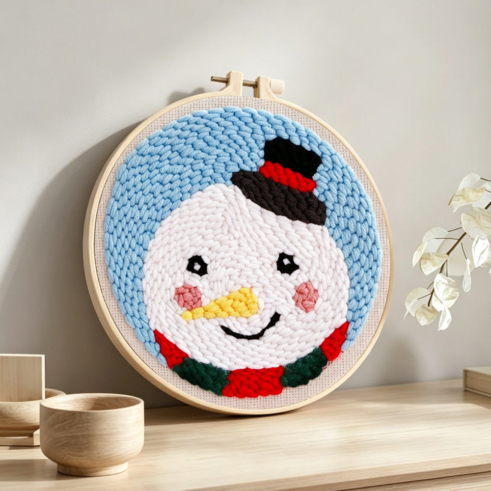 Sweet snowman with top hat punch needle artwork displayed on a table