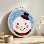 Sweet snowman with top hat punch needle artwork displayed on a table