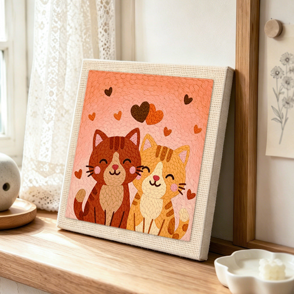 Sweet snuggling cat couple punch needle artwork displayed on a table