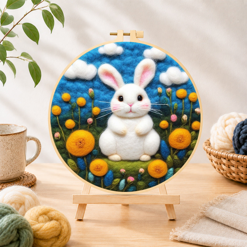 Finished sweet white bunny among yellow flowers needle felting displayed on a wooden easel