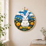 Sweet white bunny among yellow flowers needle felt wall art displayed in a bright home interior