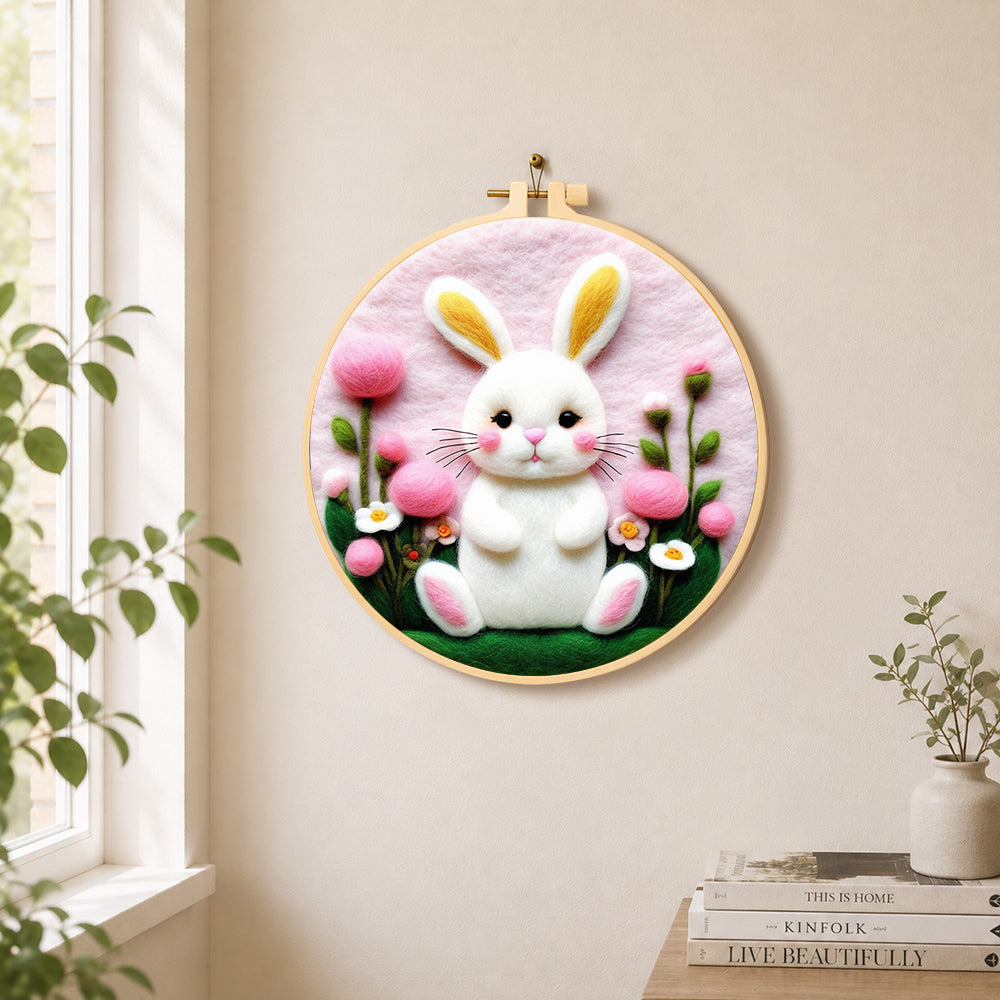 Sweet white bunny and pink flowers needle felt wall art displayed in a bright home interior