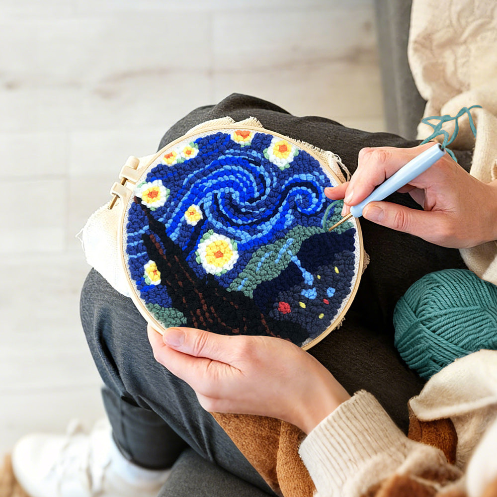 Creating handmade swirling blue night sky with glowing stars punch needle artwork