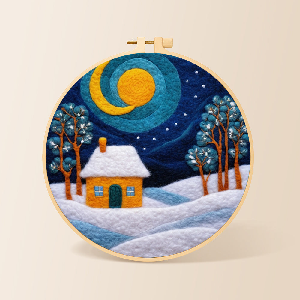 Swirling blue sky and yellow snowy cottage needle felting kit for beginners with a round wooden frame
