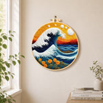 Swirling ocean and sunset needle felt wall art displayed in a bright home interior