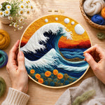 Creating the swirling ocean and sunset wool painting by hand with a felting needle