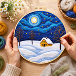 Creating the swirling starry night and snowy cottage wool painting by hand with a felting needle