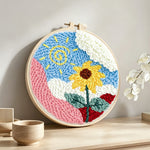 Swirly sun and cheerful sunflower punch needle artwork displayed on a table