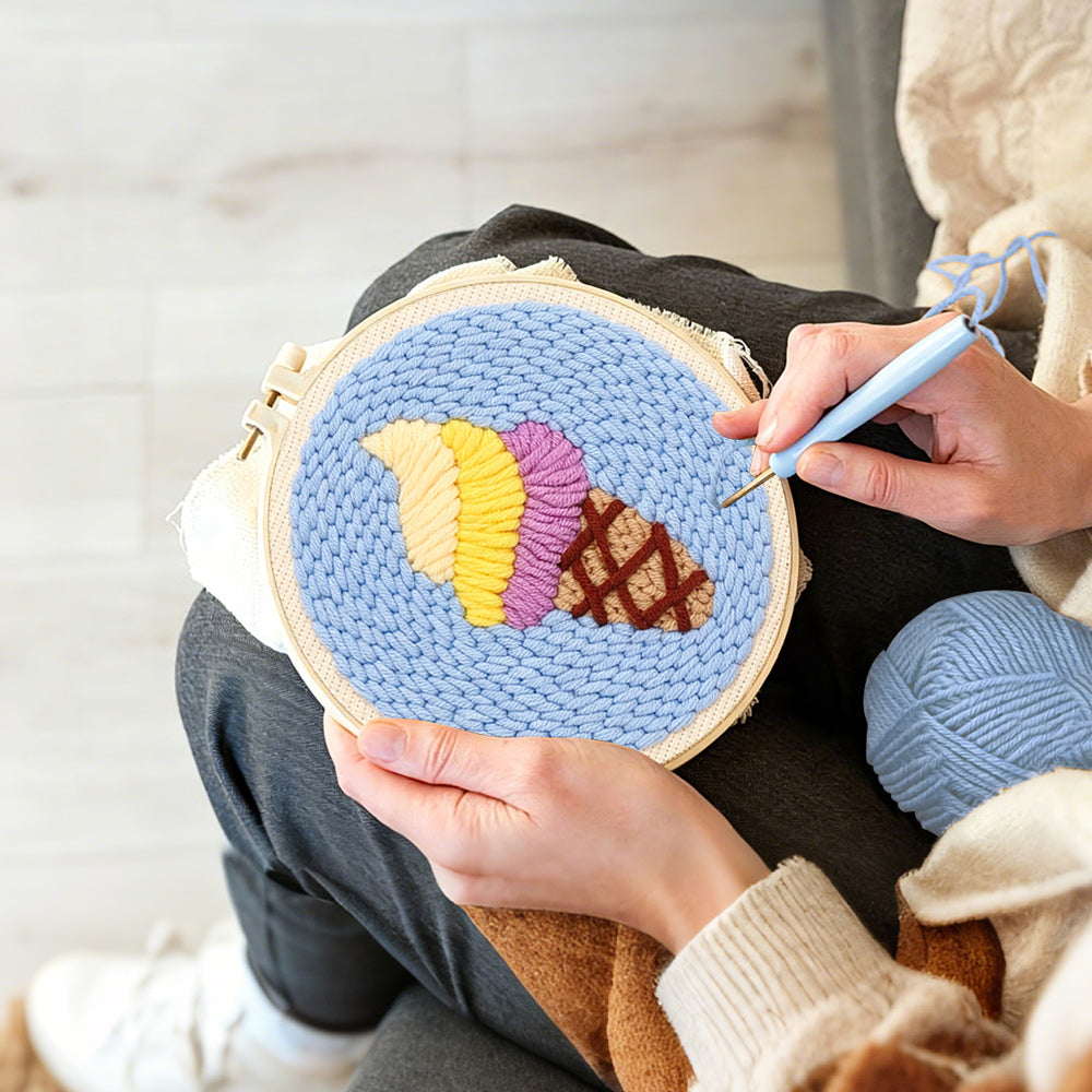Creating handmade swirly yellow and purple ice cream punch needle artwork