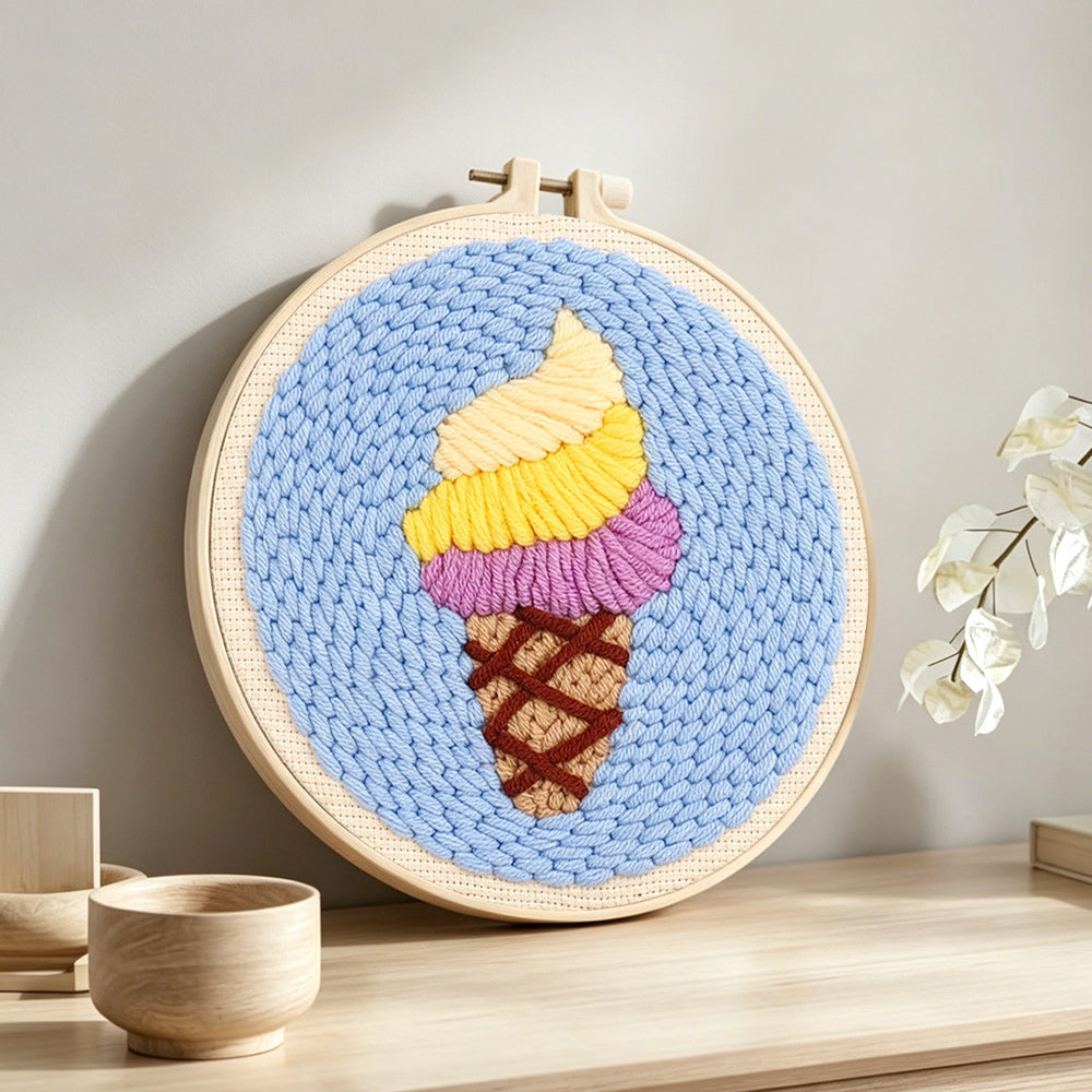 Swirly yellow and purple ice cream punch needle artwork displayed on a table